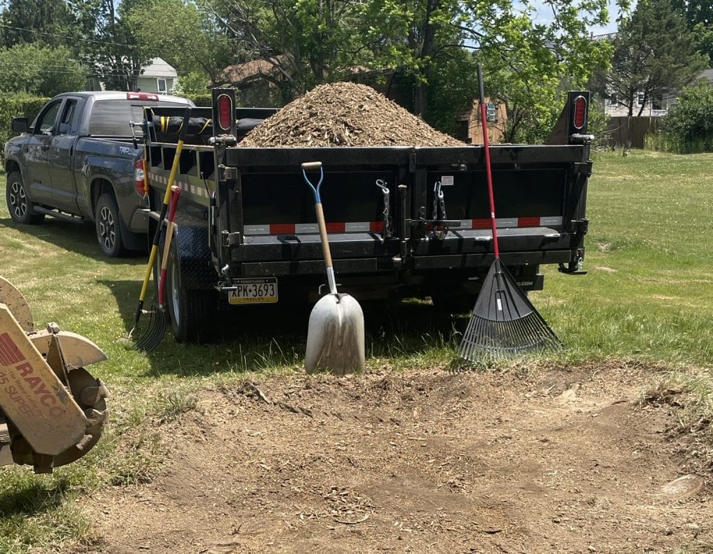 stump removal near street with tools